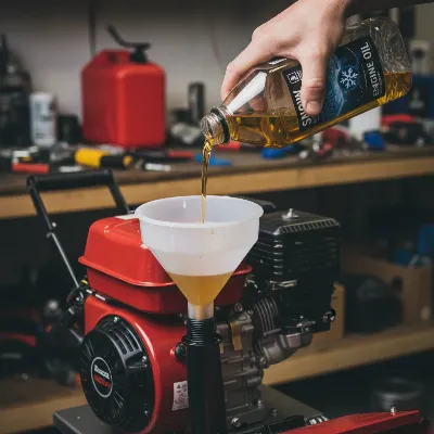 A person using a funnel to carefully pour fresh, golden engine oil into the fill port of a 4-cycle snow blower, emphasizing clean oil addition.